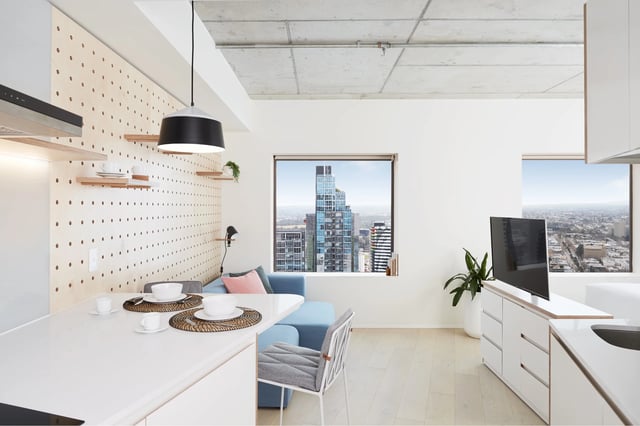 Sofa dining chairs TV kitchen counter living room at Scape Swanston in Melbourne Student Accommodation