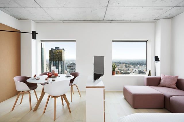 Dining table chairs sofa television living area at Scape Swanston in Melbourne Student Accommodation