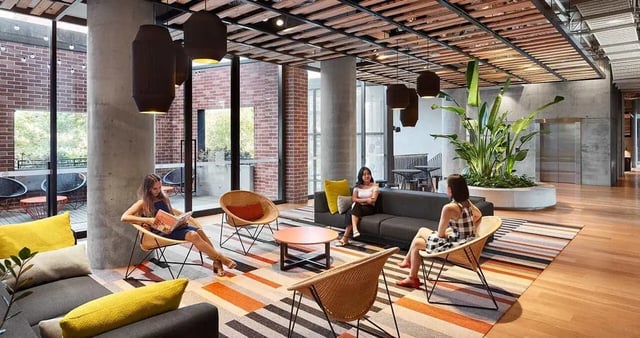Sofa chairs coffee table rug modern lobby at Iglu Redfern in Sydney Student Accommodation