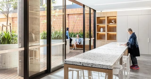 Communal kitchen with dining bar and courtyard seating area Kitchen at Iglu Redfern in Sydney Student Accommodation