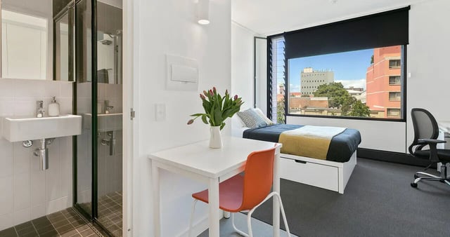 Sink shower bed desk chair bedroom exterior at Iglu Redfern in Sydney Student Accommodation