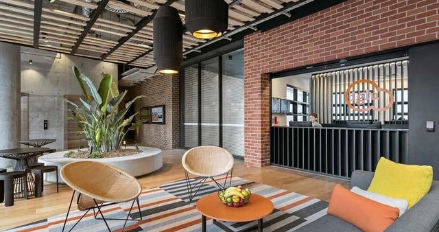 Wicker chairs table lounge area and reception Living room at Iglu Redfern in Sydney Student Accommodation