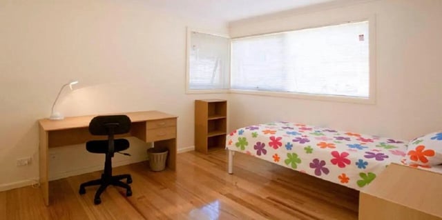 Desk chair lamp and bed bedroom at Sunset House in Melbourne Student Accommodation