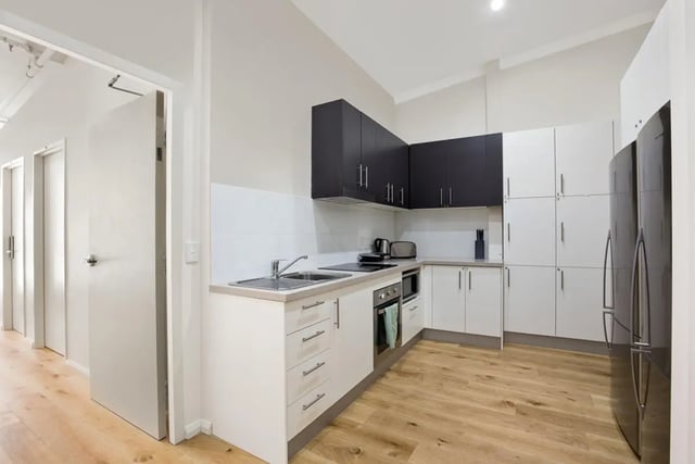 White and black cabinets sink oven refrigerator kitchen at Link2 Central in Sydney Student Accommodation