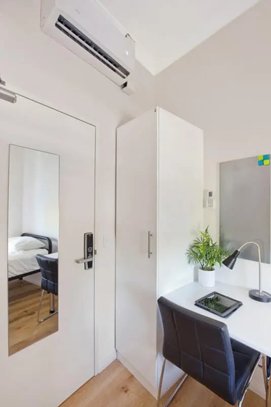 Bed desk wardrobe mirror air conditioning bedroom at Link2 Central in Sydney Student Accommodation