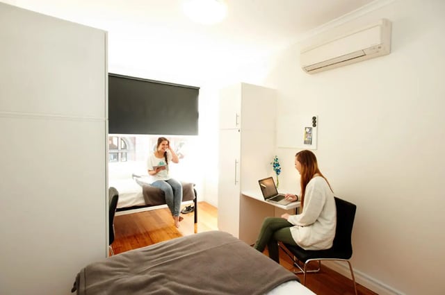 Two students study and relax in bedroom at Link2 Broadway in Sydney Student Accommodation
