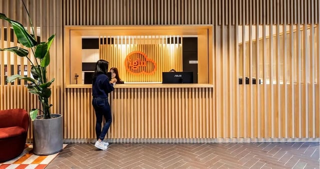 Reception desk with two people and plant lobby at Iglu Broadway in Sydney Student Accommodation