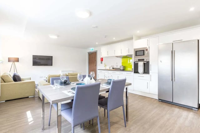 Dining table with chairs modern kitchen living room. at The Foundry in Leeds Student Accommodation