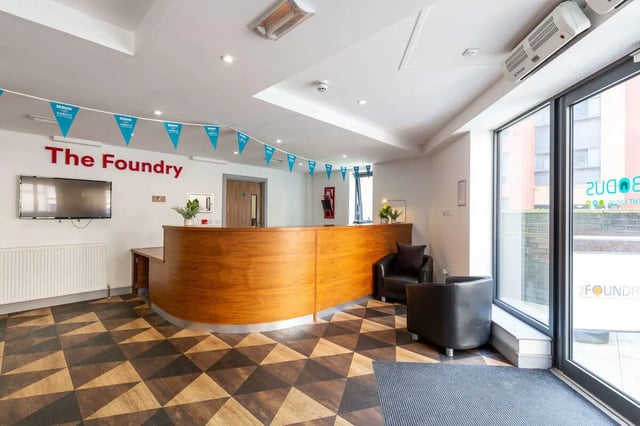 The Foundry reception desk with chairs and TV lobby at The Foundry in Leeds Student Accommodation
