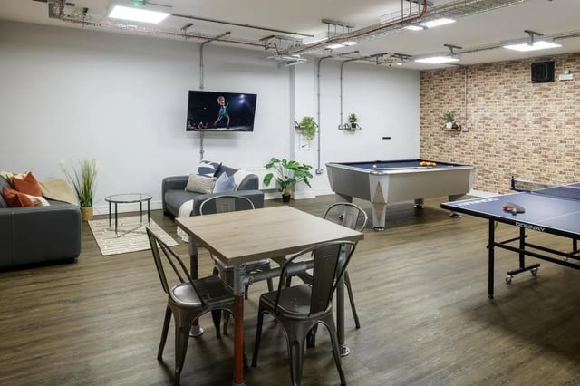 Table chairs sofas pool table ping pong table common area at The Foundry in Leeds Student Accommodation