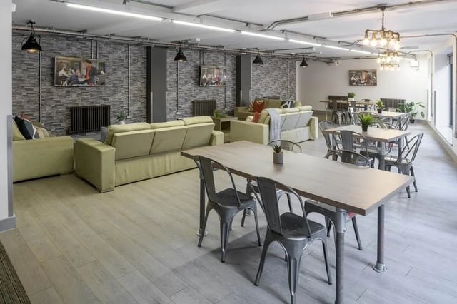 Sofa tables chairs and television common area at The Foundry in Leeds Student Accommodation
