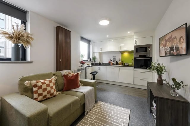 Sofa kitchen cabinets microwave TV living room at The Foundry in Leeds Student Accommodation