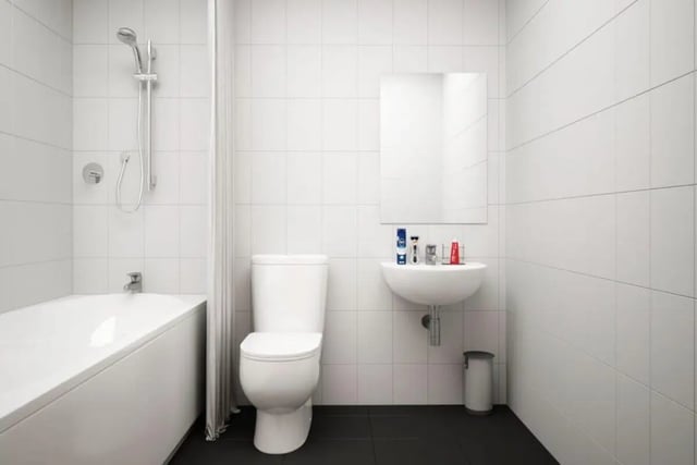 Bathtub toilet sink mirror shower and trash bin bathroom at Moss Court in Manchester Student Accommodation