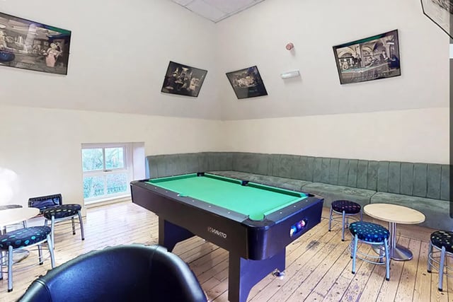 Pool table seating area with stools gaming area at Oxley Residence in Leeds Student Accommodation