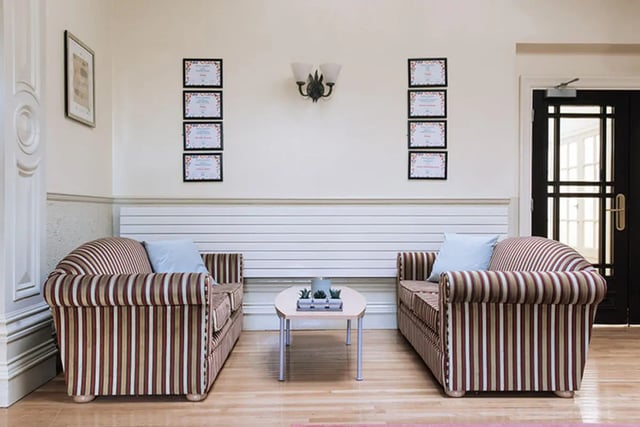 Two striped sofas with blue cushions living room at Oxley Residence in Leeds Student Accommodation