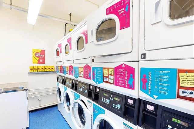 Stacked washing machines with guides laundry room at Oxley Residence in Leeds Student Accommodation