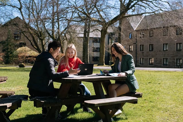 Students study on a picnic table exterior at Oxley Residence in Leeds Student Accommodation