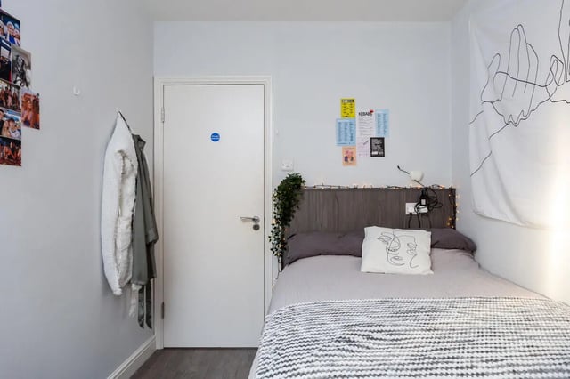 Bed with pillows tapestry and fairy lights bedroom at Thornville Court Leeds in Leeds Student Accommodation