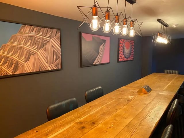 Large wooden table with chairs and art study area at Hyde Park in Leeds Student Accommodation