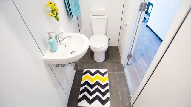Sink toilet yellow flowers rug bathroom at UniLodge Park Central in Brisbane Student Accommodation