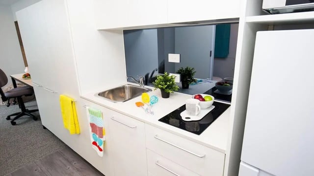 White cabinets sink induction hob fruit bowl kitchen at UniLodge Park Central in Brisbane Student Accommodation