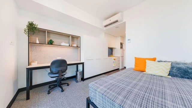 Desk chair shelves bed and kitchenette studio apartment at UniLodge Park Central in Brisbane Student Accommodation