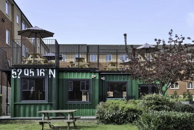 Green shipping containers with balconies exterior at Madison Gardens in Nottingham Student Accommodation