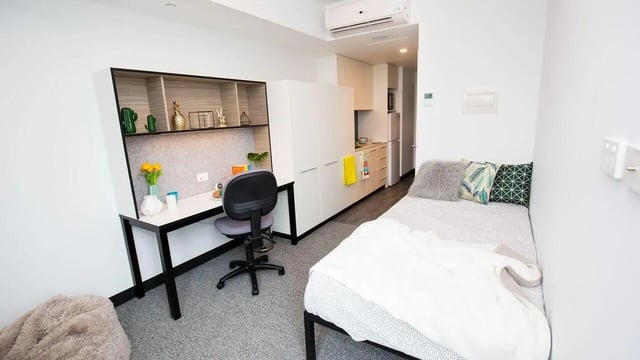 Desk bed kitchen cabinets bed with pillows exterior at UniLodge Park Central in Brisbane Student Accommodation