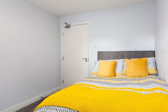 Bed with yellow pillows and grey headboard bedroom at Royal Park Road in Leeds Student Accommodation