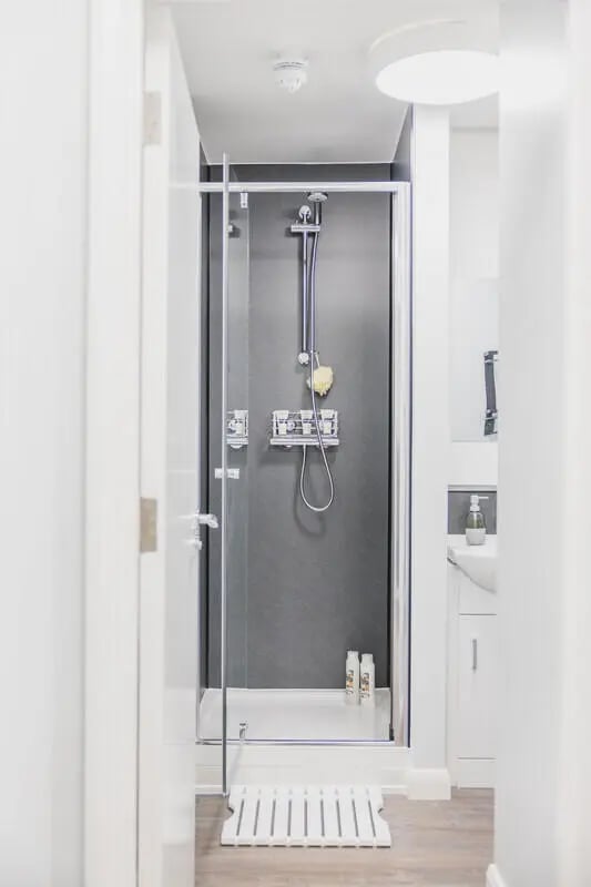 Shower stall with soap dispenser and mat bathroom at Beech Gardens in Birmingham Student Accommodation