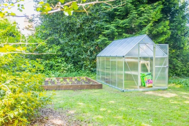 Greenhouse with raised garden bed exterior at Beech Gardens in Birmingham Student Accommodation