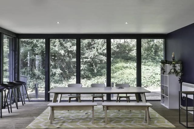 Dining table benches chairs bar stools shelving living area at Beech Gardens in Birmingham Student Accommodation
