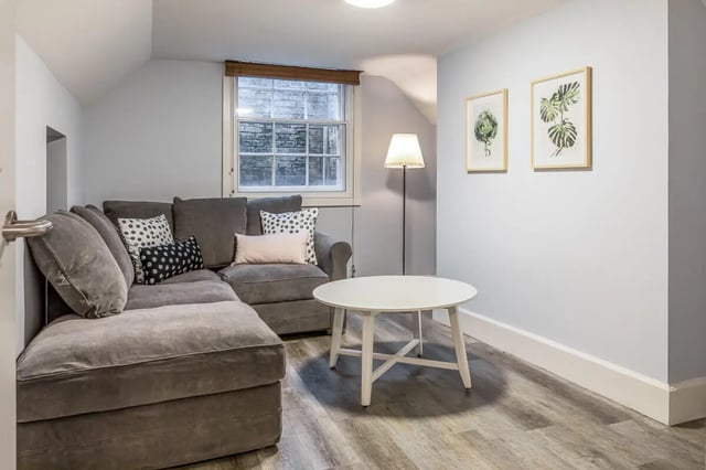 Sectional sofa round coffee table framed art living room at Standard Hill in Nottingham Student Accommodation