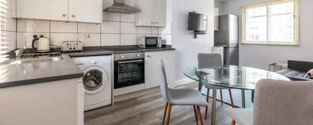 Kitchen with washer oven table and chairs kitchen at The Coach House in Nottingham Student Accommodation