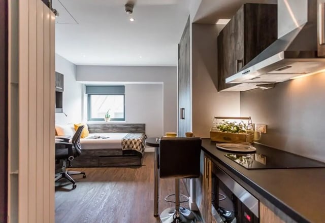 Bed desk and kitchen area studio apartment at Queens Court in Reading Student Accommodation