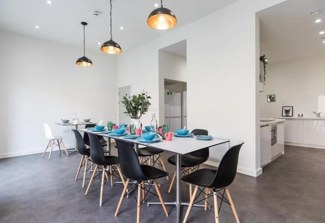 Dining table set for meals with chairs kitchen living room at The Cam Foundry in Cambridge Student Accommodation