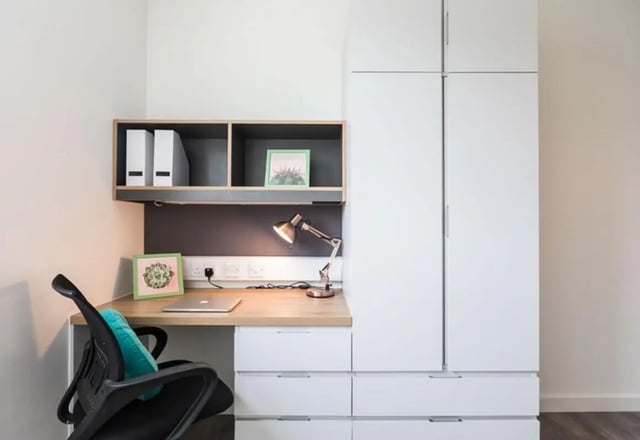 Desk, chair, shelves, lamp, laptop, wardrobe, study area at The Cam Foundry in Cambridge Student Accommodation