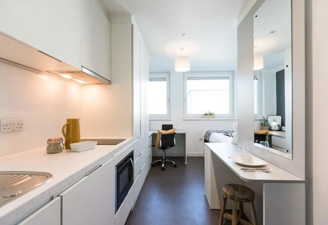 Modern kitchen studio with bed and desk. at Vogue Studios in Brighton Student Accommodation