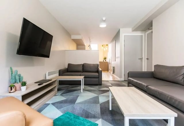 Two sofas coffee table television living room at Caton Court in Lancaster Student Accommodation