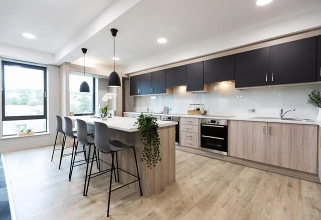 Island with stools and modern cabinets kitchen at Caton Court in Lancaster Student Accommodation