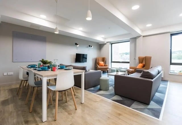 Dining table with chairs and sofas living room at Caton Court in Lancaster Student Accommodation