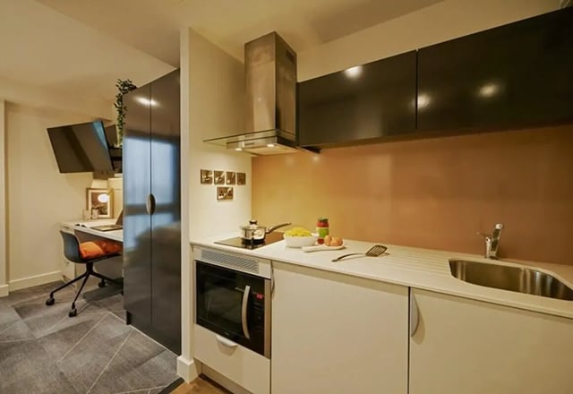 Desk television microwave cooking area kitchen at aparto Glasgow West End in Glasgow Student Accommodation