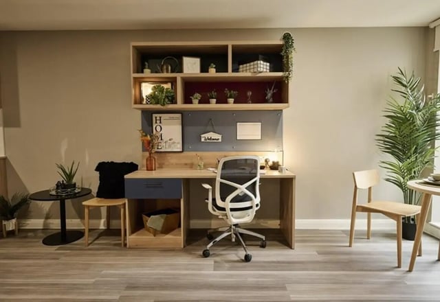 Desk shelf chair plants and small table study area at The Spireworks in Oxford Student Accommodation