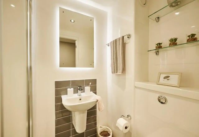 Sink mirror towel roll and toilet interior bathroom at The Spireworks in Oxford Student Accommodation