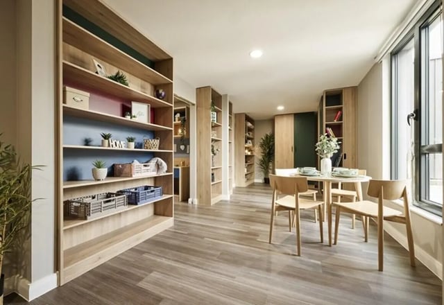 Bookshelves and dining table with chairs living room at The Spireworks in Oxford Student Accommodation