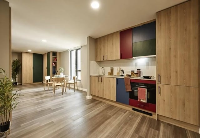 Kitchen dining area with table chairs and cabinets kitchen at The Spireworks in Oxford Student Accommodation