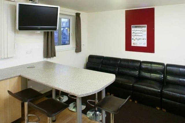Lounge area with sofa and bar table living room at Asha House in Loughborough Student Accommodation