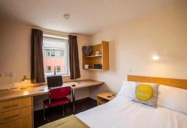 Desk with laptop and red chair bedroom at Asha House in Loughborough Student Accommodation
