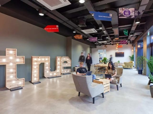 Large wooden letters and students working communal area at True Swansea in Swansea Student Accommodation