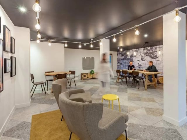 Seating area tables chairs and people common area at True Birmingham in Birmingham Student Accommodation